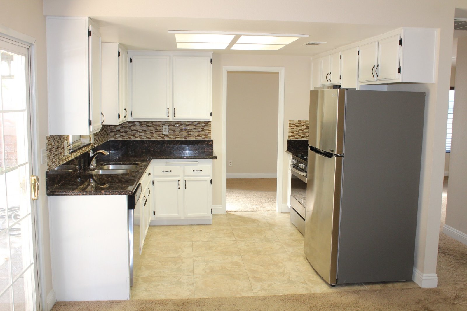 Single-story home with patio and garage property image